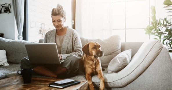 woman working on laptop with her dog