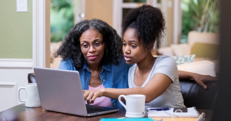 mother and daughter calculating student loan interest