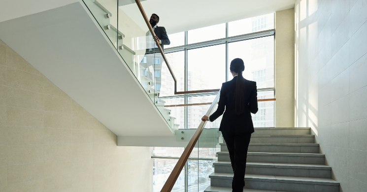 woman walking up stairs in an office building
