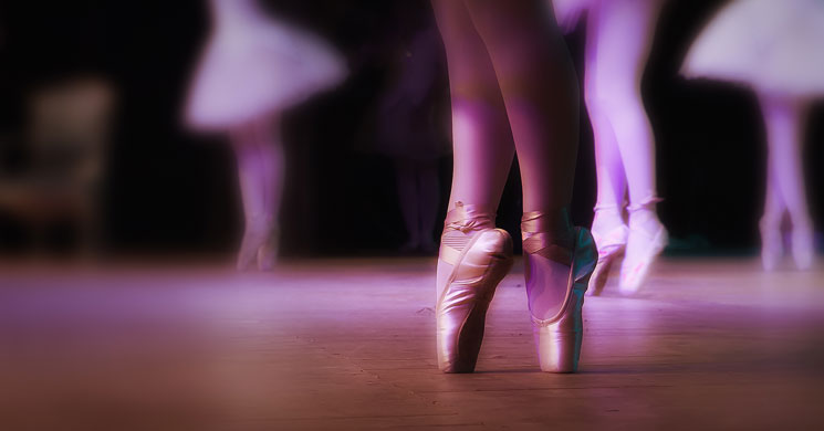four ballerina's feet as they dance